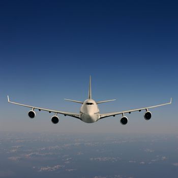 An Airliner in Flight over Clouds