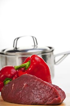 raw meat on a wooden chopping board