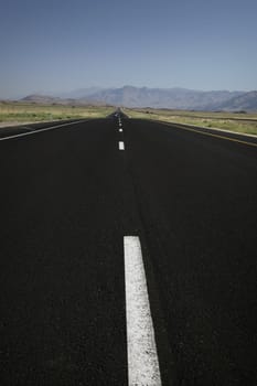 black road leading straight to the horizon