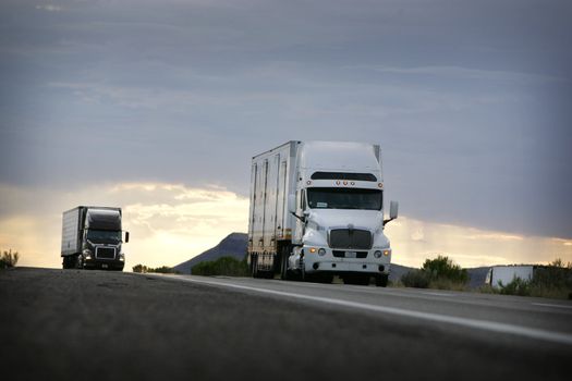 truck driving on a freeway at sunset