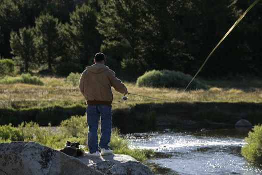 man flyfishing on a river