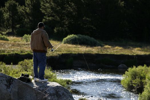 man flyfishing on a river