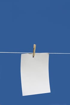 paper hanging from a clothes line with a blue background