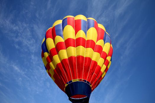 Hot air balloon on blue background with red blue and yellow highlights.