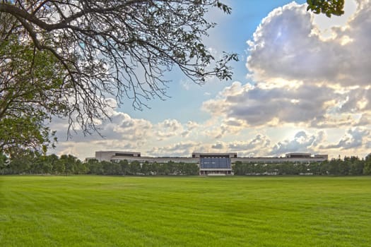 A building surrounded by nature on the far side of the lawn