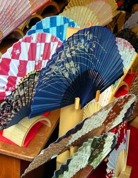 A very colourful arrangement of paper Japanese fans.          
