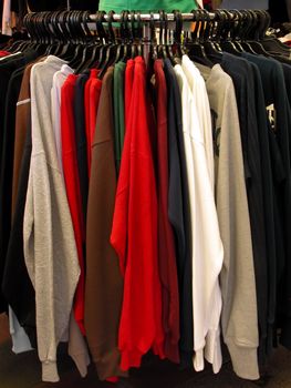  blouses stand in a street clothes shop.         