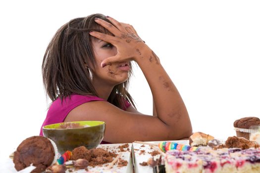 Pretty black woman having eating a pile of sweets and now looking nauseaus