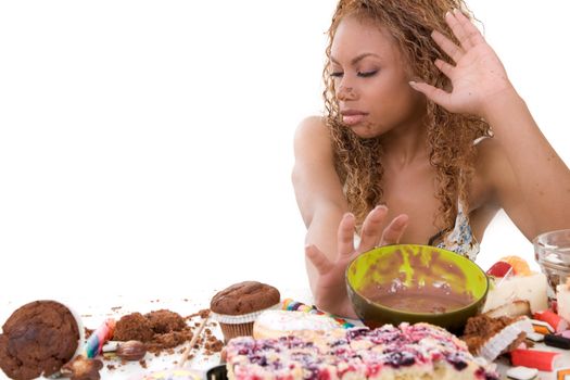Black woman pushing away all the food that she has just eaten