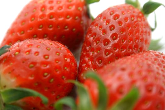 Close-up of brightly red strawberries on a white background.