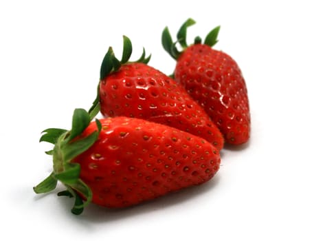 Three strawberries on a white background.