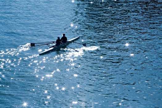 Two persons with oars in a kayak in the sea in a sunny day 
