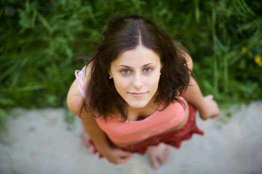 The young girl with blue eyes and dark hair looks in a shot, having lifted a head

