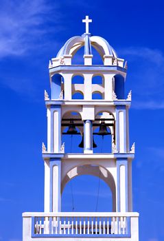 Greek church bell tower with a blue sky background