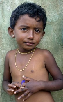 Neluwa; Sri Lanka - January 27; 2011: Portrait of a littlel Sri Lankan girl  from small village in Sinharaja Rain Forest. Sinharaja Rain Forest is the last viable area of primary tropical rainforest in Sri Lanka. The Rain Forest is a UNESCO World Natural Heritage Site.