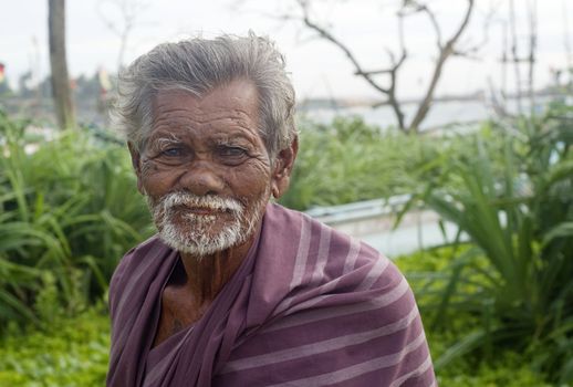 Hikkaduwa, Sri Lanka - February 2, 2011: Portrait of a poor Sri Lankan man.About 80 percent of Sri Lanka 's population lives in its rural areas. The rural poor account for 95 percent of the country's poor. 