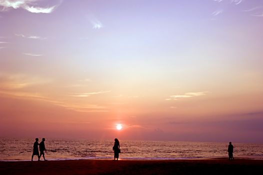 People on the ocean beach at sunset. Sri Lanka