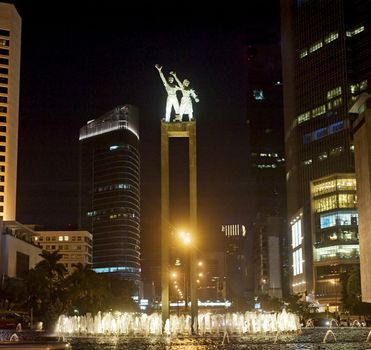 The bronze welcome statues stands high above a busy roundabout in Jakarta, Indonesia