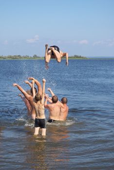 photo of the person jumping with heights in water