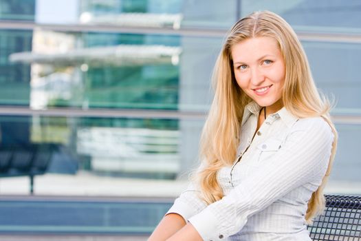 Beautiful attractive blonde business woman looking at you being sweet