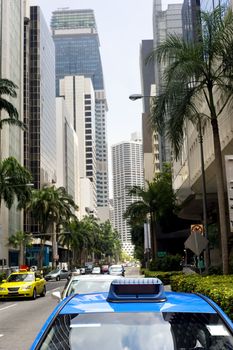 Taxi in the central sreet in Singapore. Sharpness on a blue car