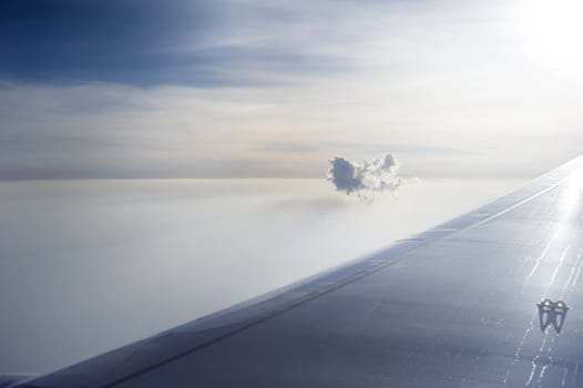Lonely cloud above the clouds. View from airplane