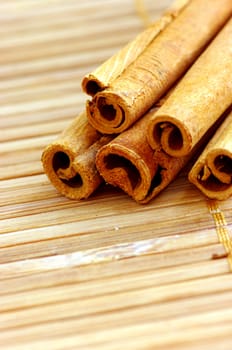 Cinnamon sticks on white background on the mat