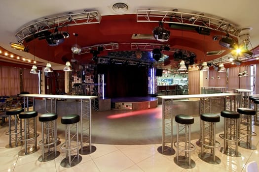 Interior of night club with a bar and a scene