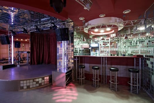Interior of night club with a bar and a scene