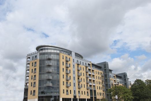 Modern Cream Stone and Smoked Glass Apartments under a summer sky