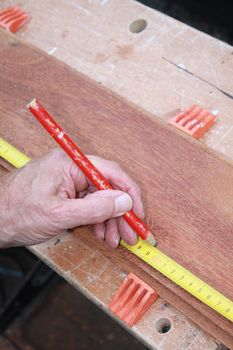 A Carpenter Getting Ready For Work, drawing a line on wood
