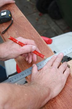 A Carpenter Getting Ready For Work, drawing a line on wood
