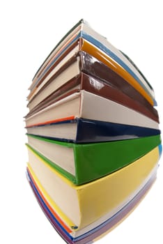 Closeup of books stacked one over the other isolated on white