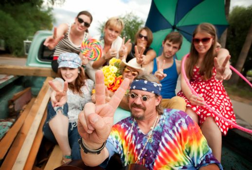 Groovy Group in the Back of Truck Making Peace Signs