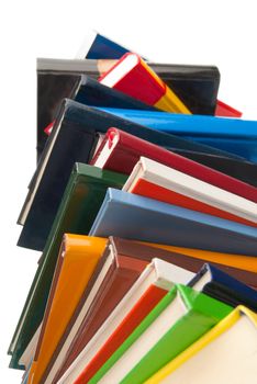 Colorful Books stacked one over the other isolated on white