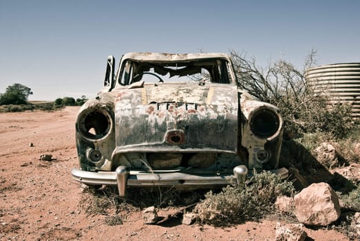 an old car in the desert rusts away