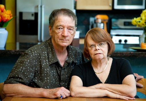 Senior couple at a table in their modern kitchen