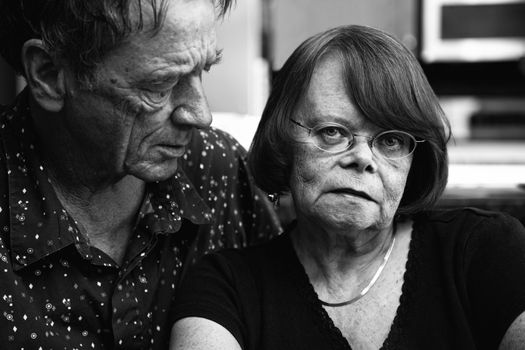 Worried Senior Couple at Home in Modern  Kitchen