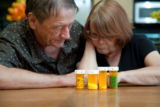 Senior Couple at Home Reading Prescription Bottle Labels