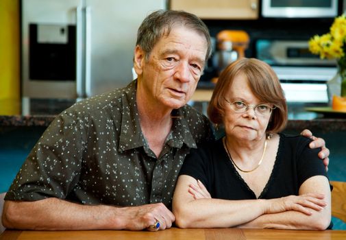 Senior couple at a table in their modern kitchen