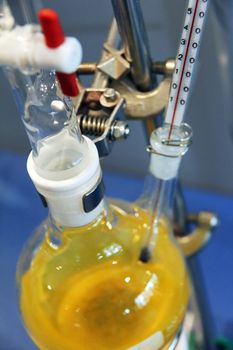 chemical laboratory with yellow liquid and bottles