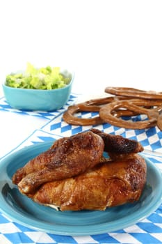 Roast chicken with salad and pretzels on a plate