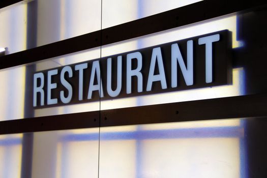 white signboard with the word restaurant in the window