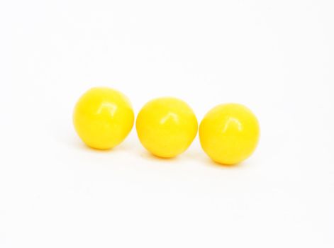 three yellow vitamins . macro