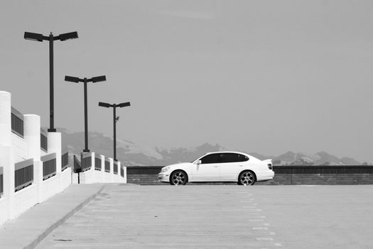 White Lexus GS with chrome rims and tinted windows.