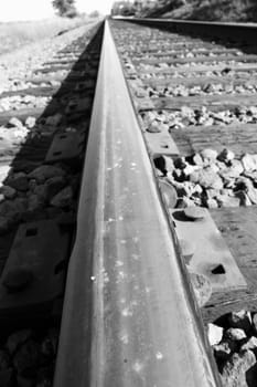 Close up of a rail track going into the horizon.