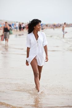 Beautiful brazilian girl going for an easy stroll along the beach