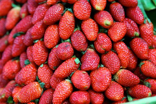 Close-up of freshly strawberries at a market stall.