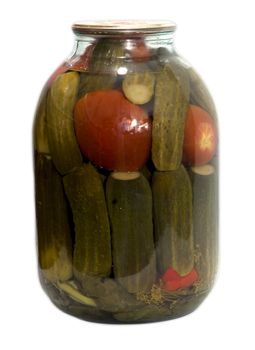 In a glass jar marinaded cucumbers and tomatoes on a white background 