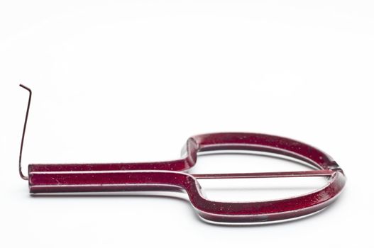 closeup of a red jaw harp